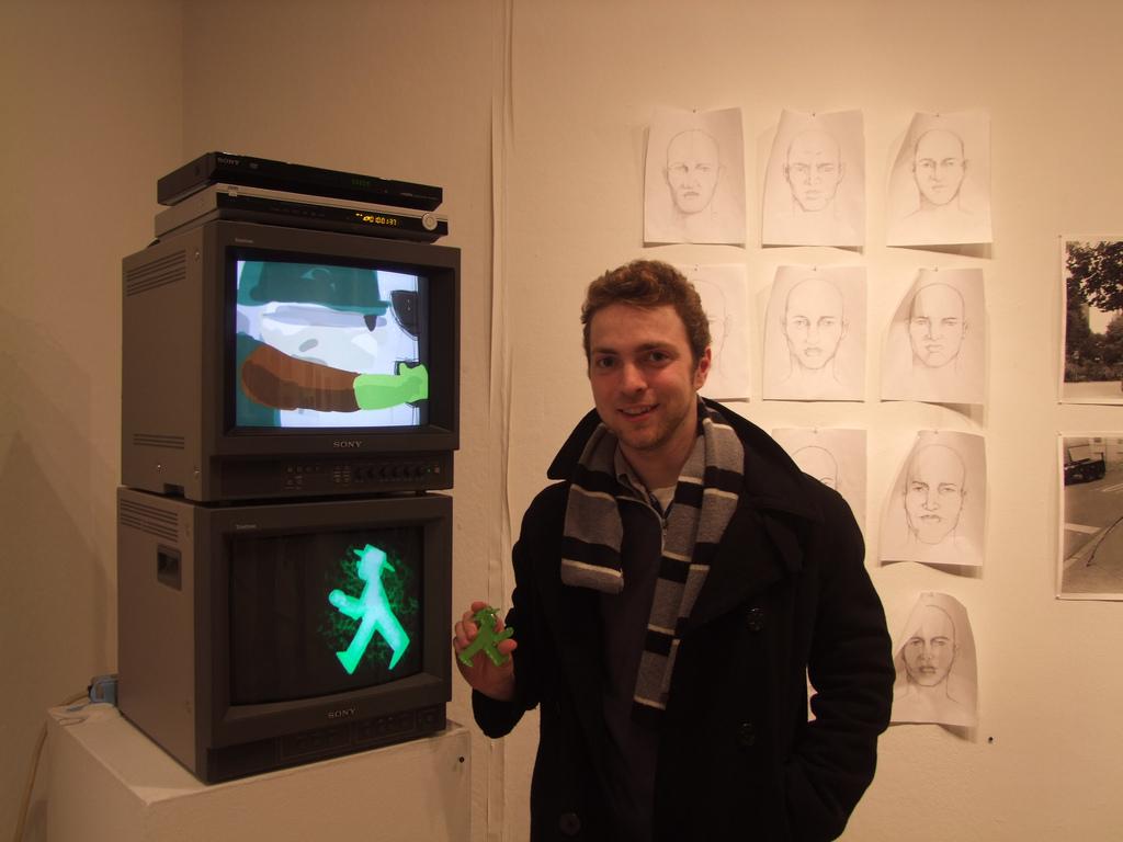 Tim Leuke, FCLC '13, with his work in the senior exhibition in the main gallery. (Ludovica Martella/The Observer)