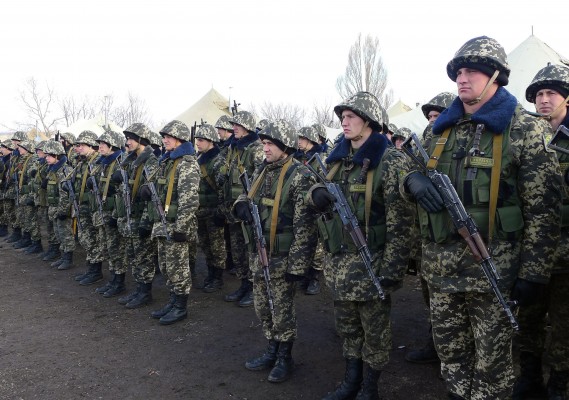 Ukrainian reservists line up for photographers at newly established base near the Russian border. (Roy Gutman/MCT)