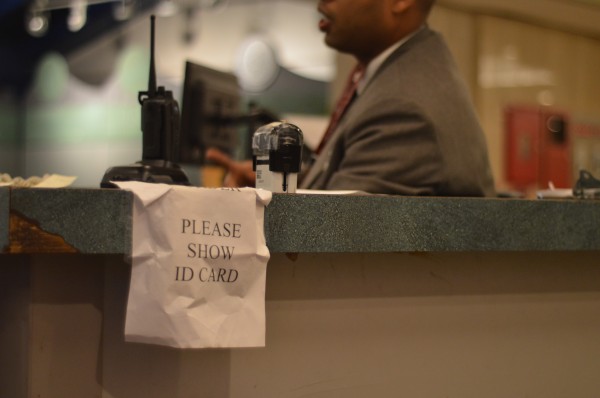 Signs over RFID scanners at the entrance of Lowenstein tell students and faculty to show their IDs. (Ian McKenna/The Observer)