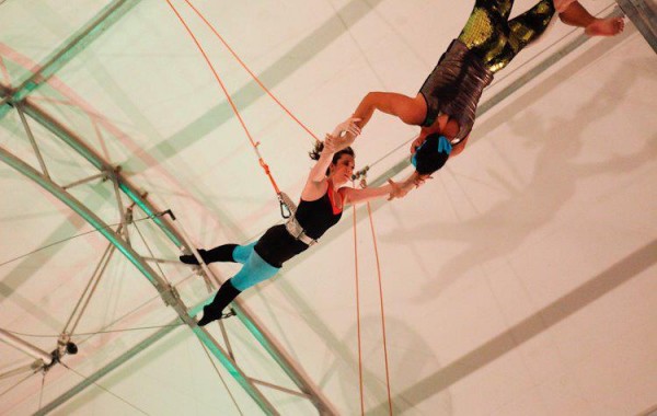 Lauren Plumley, FCLC ’16, is a former gymnast-turned-circus performer. Her speciality is the trapeze, seen here, as the flyer who soars through the air and into the arms of the catcher. (Photo Courtesy of Lauren Plumley)