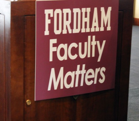 Sign on the podium during the Faculty wide meeting; t-shirts were also being sold with this design, with funds going to the Faculty Senate's legal fund. (Tyler Martins/The Observer)