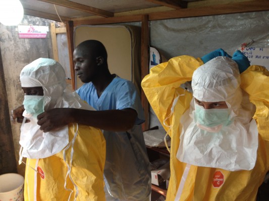 Aid workers prepare for contact with a diagnosed Ebola case in Guinea. (courtesy European Commission DG ECHO via Flickr) 
